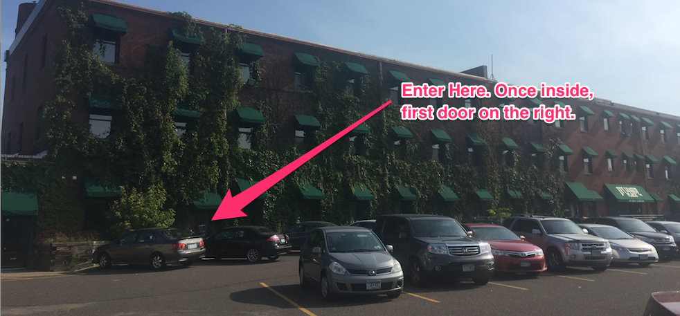 building with arrow pointing at the door on far west end of building